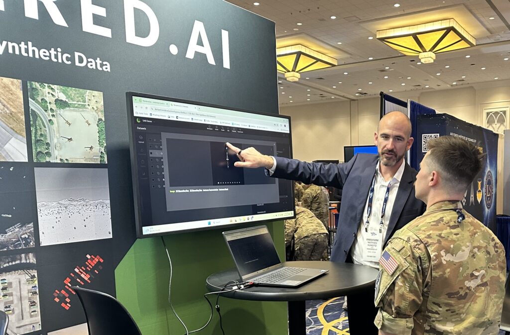 Rendered.ai's CEO, Nathan Kundtz, showcasing the capabilities of the company's synthetic data generation to a group of airmen at the 2024 Air, Space & Cyber Conference.